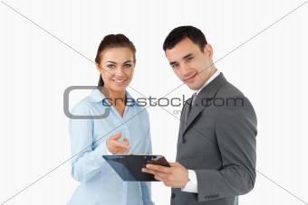 Smiling business partners with clipboard