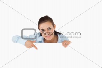 Businesswoman pointing on sign under her