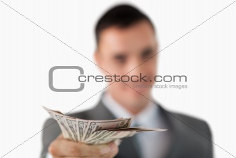 Close up of bank notes being held by businessman