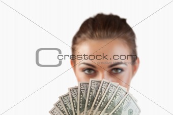 Close up of bank notes being held by businesswoman