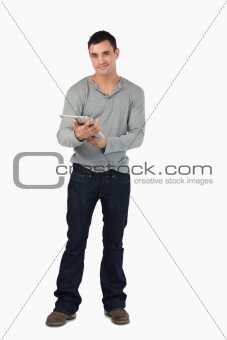 Smiling young male using his tablet