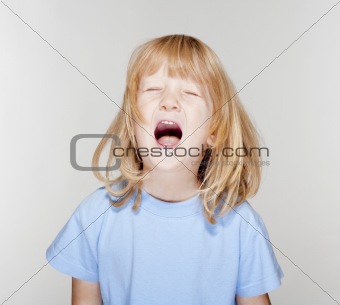 portrait of a boy with long blond hair crying - isolated on white