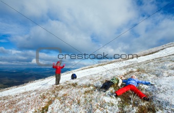 Family on autumn  mountain plateau  with first winter snow