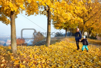 Family in autumn maple park