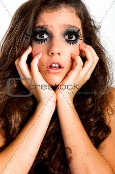 Terrified young girl with extreme makeup