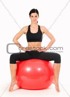 Brunette woman excercising with a pilates ball