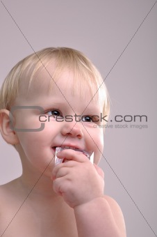 toddler biting a toy