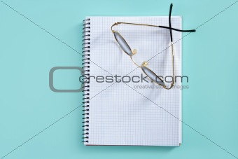 doctor teacher glasses on blank spiral notebook