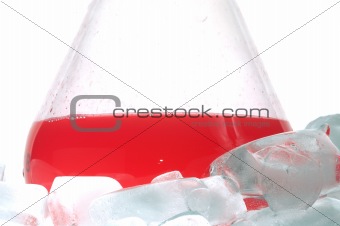 red liquid in Flask behind ice
