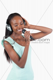Smiling young woman singing