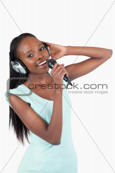 Happy smiling young woman singing