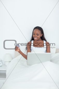 Portrait of a young woman booking her holidays online