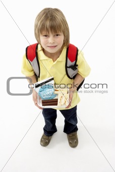 Studio Portrait of Smiling Boy Holding Lunchbox