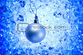 christmas silver bauble on blue winter ice