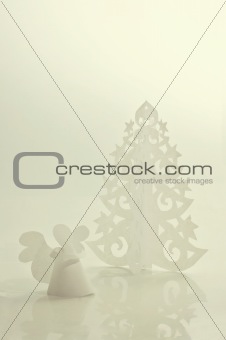 Handmade angel and Christmas tree cut out from office paper