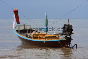 Longtail boat in morning sun at Kamala shore