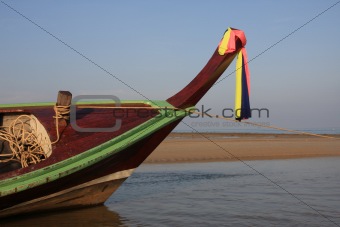 Longtail boat waiting for tide at Kamala beach