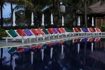 Sunbeds lined up at pool close to Kamala beach