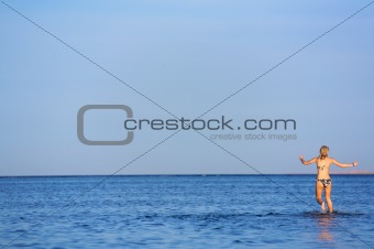 Young Woman playing in the Sea
