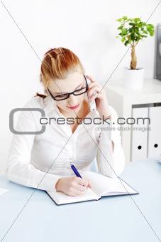 Caucasian businesswoman answering the phone.