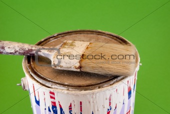 tin of painting and brush