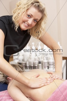 Female masseuse with client