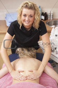 Female masseuse with client