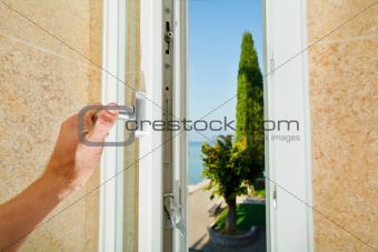 Hand opening the window