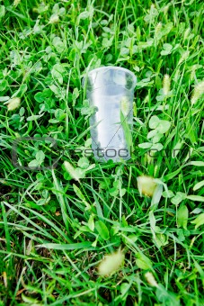 Plastic glass on a green grass