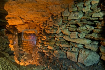 The stone wall in the underground catacombs.