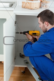 Portrait of a handyman fixing a door