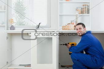 Happy handyman fixing a door