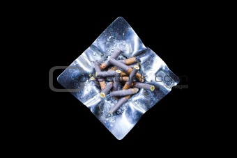 Decorated silver ashtray with cigarette butts