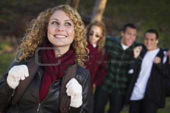 Pretty Young Teen Girl with Three Boys Behind Admiring Her.
