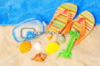 Seashells and diving mask on the beach