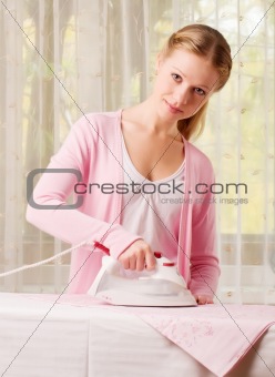 Happy woman ironing clothes