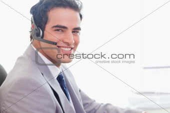 Side view of smiling businessman with headset on