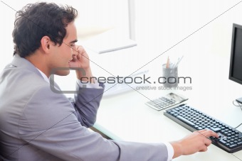 Side view of businessman typing on his keyboard