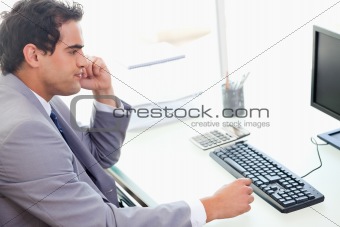 Side view of businessman sitting at his desk