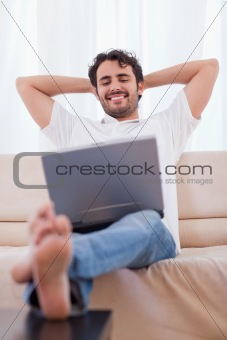 Portrait of a happy man using a laptop