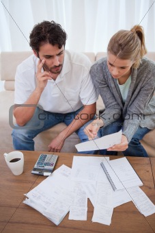 Portrait of a worried young couple doing their accounting