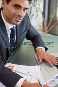 Portrait of a focused sales person studying statistics