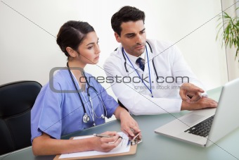 Doctors working with a notebook