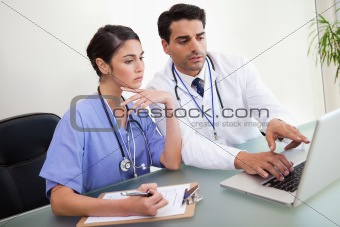 Young doctors working with a notebook