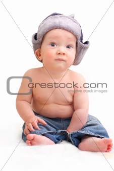 Cute baby boy in cap with ear-flaps (ushanka)