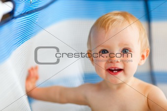 Portrait of happy baby in playpen

