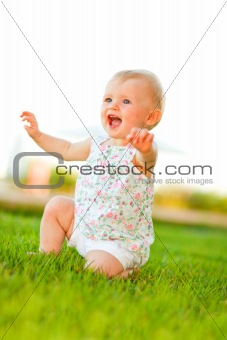 Happy baby playing on grass
