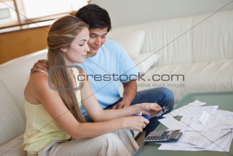 Young couple cutting their credit card