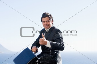Cheerful businessman with the thumb up