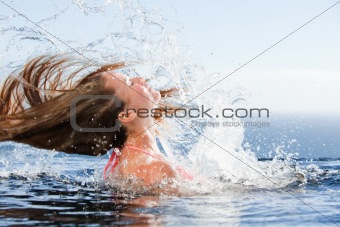 Beautiful woman raising her head out of the water